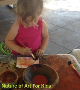 toddler painting with natural veggie paints in art class